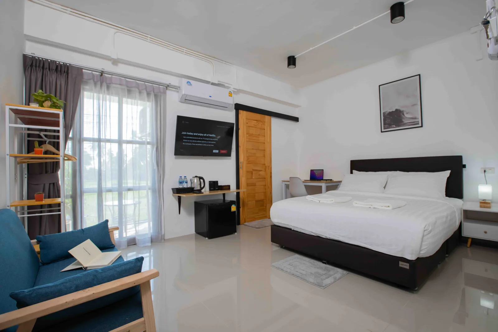 A private room at Laewan Guesthouse, with king bed and balcony.